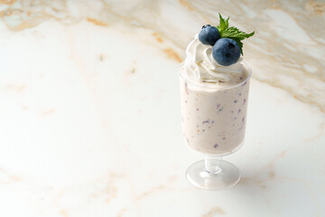 Mousse dessert with cream in glass on the table.