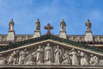Tympanum and the statues of the church of Saint Vincent de Paul on a sunny day (blue sky), Paris,...