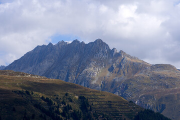Mountain panorama with peak at Swiss mountain pass Oberalppass on a sunny late summer morning. Photo taken September 5th, 2022, Oberalp Pass, Switzerland.