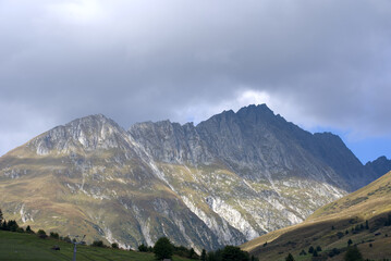 Fototapeta premium Mountain panorama with peak at Swiss mountain pass Oberalppass on a sunny late summer morning. Photo taken September 5th, 2022, Oberalp Pass, Switzerland.
