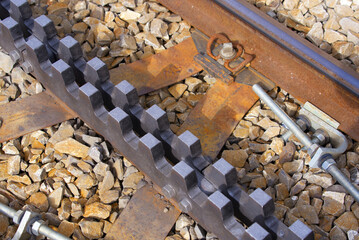 Close-up of railway track with cog wheels of narrow gauge railway at Swiss mountain pass Oberalppass on a blue cloudy late summer day. Photo taken September 5th, 2022, Oberalp Pass, Switzerland.