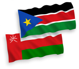 National vector fabric wave flags of Sultanate of Oman and Republic of South Sudan isolated on white background. 1 to 2 proportion.