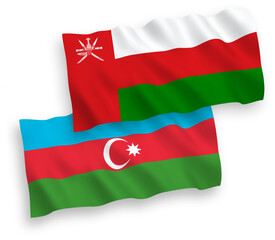 National vector fabric wave flags of Sultanate of Oman and Azerbaijan isolated on white background. 1 to 2 proportion.