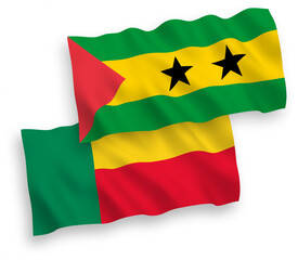 National vector fabric wave flags of Saint Thomas and Prince and Benin isolated on white background. 1 to 2 proportion.