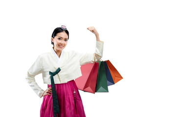 Asian woman wearing a traditional Korean national costume, Hanbok, standing while holding a shopping bag