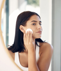Beauty, mirror reflection and woman with cotton pad for facial cleaning, makeup removal or home skincare routine. Health, wellness or face of model girl with cosmetics product for self care treatment © Rene L/peopleimages.com