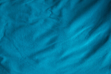 Blue fabric folds texture of natural weave cloth dark teal color fabric natural cotton or linen textile material for seamless background