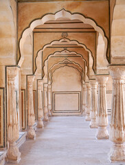 Colonnade Passageway with arched pillars at Hall of Mirrors (Sheesh Mahal) at Amber Palace, Jaipur,...