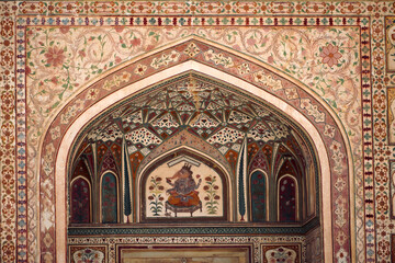 The ornate carvings on the arches and entrance walls to the ancient Amber fort in the city of...