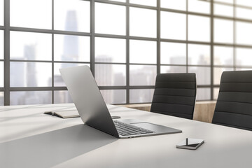 Close up of modern designer office interior with laptop, smartphone, book and window with city view. 3D Rendering.