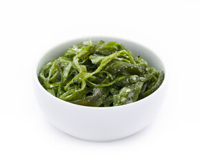 heap of fresh Korean salted seaweed salad stem side dish or Miyeok Julgi Bokkeum in white bowl isolated on white background. Laminaria or Kelp Seaweed stem