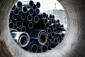 Water pipes for drinking water supply at a construction site. Underground pipeline works. Modern...