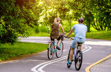 Fototapeta premium Cyclists ride on the bike path in the city Park 