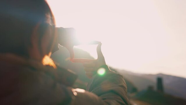 B roll - New year planning and vision concept, Close up of woman hands making frame gesture with sunset in winter, Female capturing the sunrise.