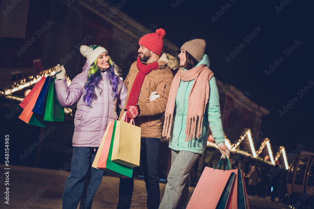 Poster photo of three cheerful friendly fellows hold packages walk speak communicate x-mas advent outside