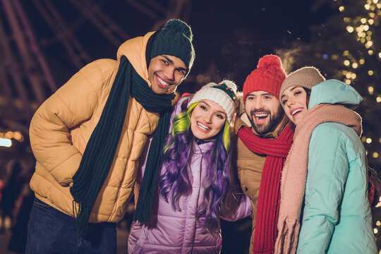 Photo of peaceful positive friendly people toothy smile good mood spend december evening outside