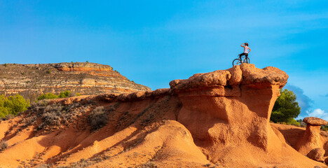Woman on mountain bike on red rock canyon- freedom,  travel,  sport concept ( sierra de armantes, ...