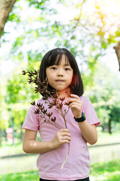 Portrait of child girl playing in summer park outdoor. kids lifestyle