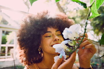 Woman, smell flowers and spring garden enviroment for plants wellness or sustainability. African...