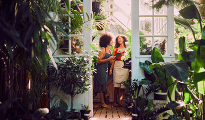 Black women, tablet or laughing in plant shop, garden center or greenhouse in growth management,...