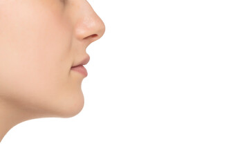 Closeup profile of female s nose and lips with no makeup on a white background
