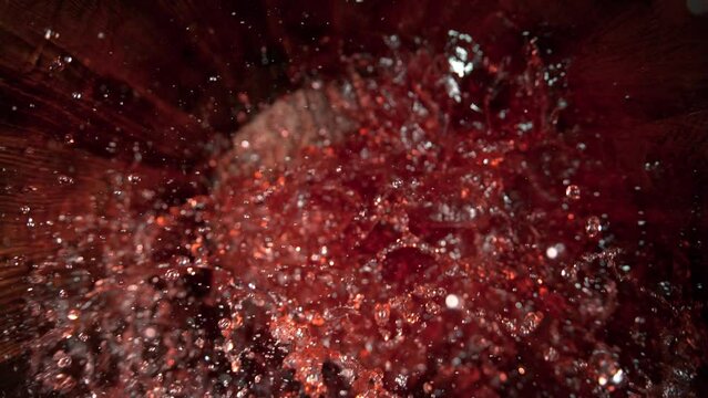 Super Slow Motion Shot of Pouring Red Wine into Old Oak Wooden Barrel at 1000fps.
