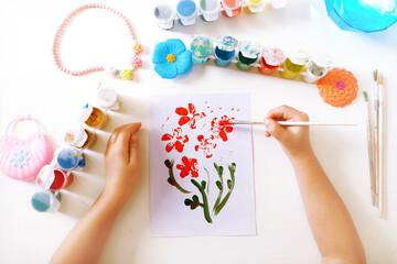 Child making homemade greeting card. little girl creating card for mom gift for Mothers day,...
