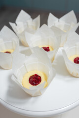 Not ready cupcakes. Pastry with jam layer without cream in white paper cover on table, top view. Homemade desserts, making of sweets