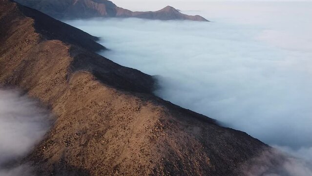 Circuling drone shot of the mountains of Lima Peru above the clouds