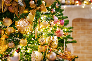 A part of Christmas tree with gold decor in a classic style.