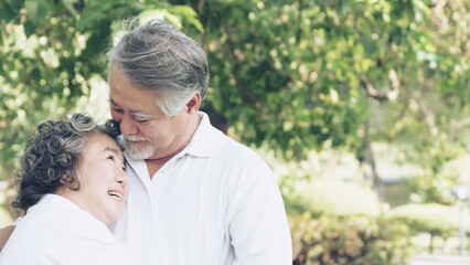 Obraz premium Happy love Elderly couple smile face , Senior couple old man and senior woman relaxing hug in a forest