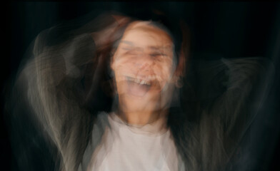 Depression, bipolar and blur face of woman in studio on black background for mental health...