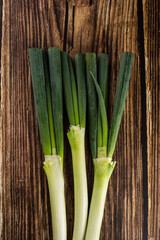 green onions on wooden background