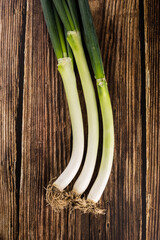 green onions on wooden background