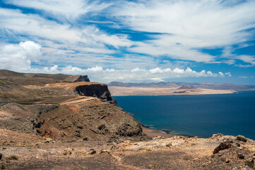 View of the coastline of island Lanzarote with clouds and blue sky