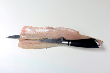 How to make pike fillets with a knife. process on a white background