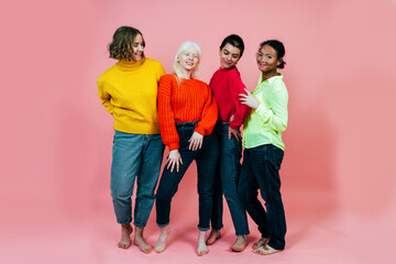 group of multiethnic women with different kind of skin posing together in studio. Concept about...
