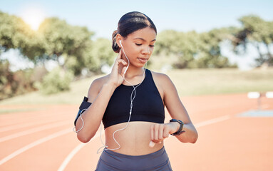 Music, earphones and runner woman pulse check on workout, training and athlete break. Wellness,...