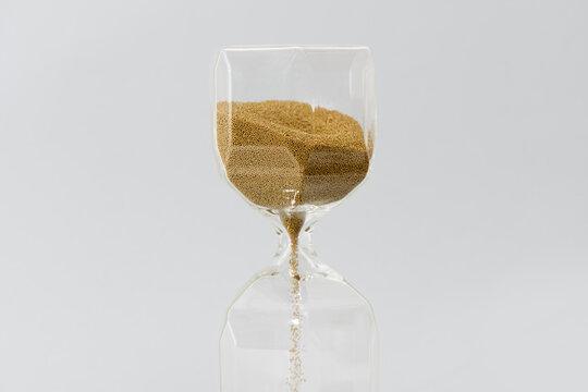 Hourglass on the gray background.