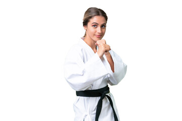Young Uruguayan woman over isolated background doing karate © luismolinero