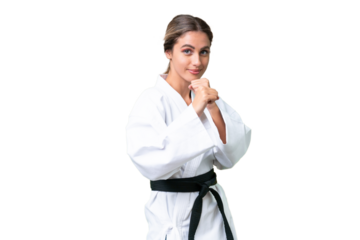 Young Uruguayan woman over isolated background doing karate