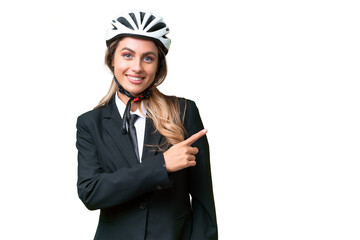 Business Uruguayan woman wearing a helmet biker over isolated background pointing to the side to present a product