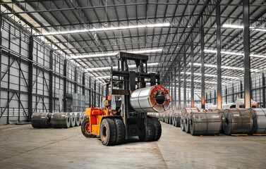Orange color forklift lifts heavy steel coil inside a warehouse at a seaport-bounded area. Raw material handling and transportation. - obrazy, fototapety, plakaty