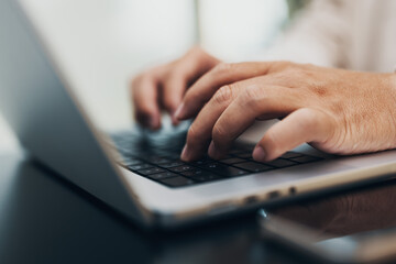closeup of hands typing on a notebook, keyboard