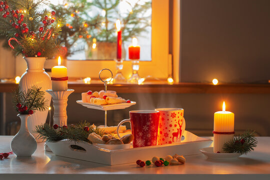 christmas decor and red cups with hot drink on kitchen