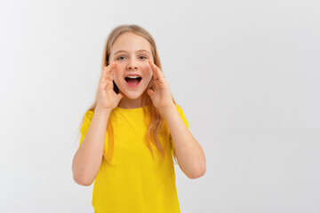 Attractive teen girl holds hands near wide open mouth is announcing, telling a secret, shouting or yelling, standing over white background. Communication and promo concept