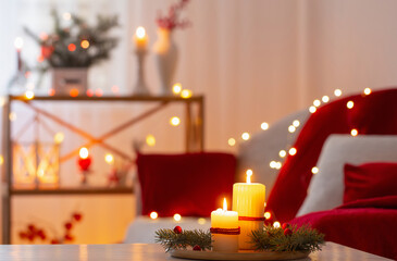 christmas decor in red color with burning candles at home
