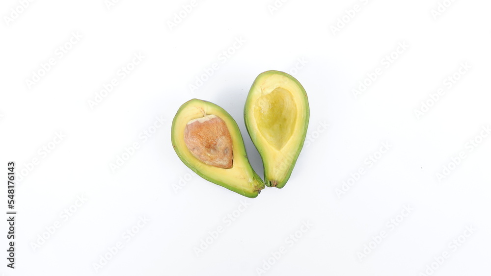 Wall mural Green avocado fruit that has been split and is ripe. Contains many vitamins for human health. Placed on a white mat.
