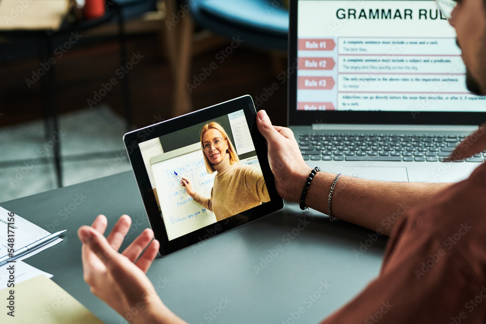 Poster confident blond tutor presenting new english grammar subject at lesson to online audience on tablet 