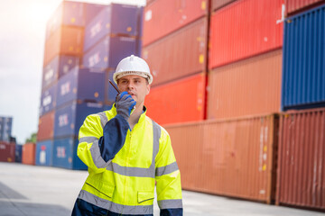 Engineer using walkie talkie checking stock into container for loading,International shipping logistics.